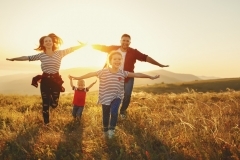 Happy family: mother, father, children son and daughter on sunset