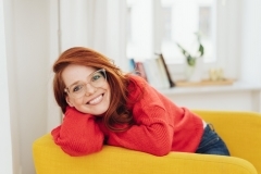 Relaxed confident woman sitting in an armchair